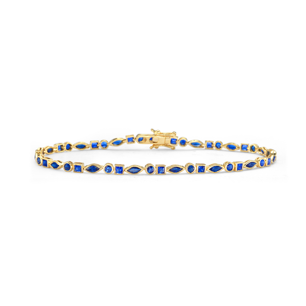 Gold bracelet with blue stones on a white background - Multi Shape Sapphire Bezel Setting Tennis Bracelet (3.50 ct.) in 14K Gold